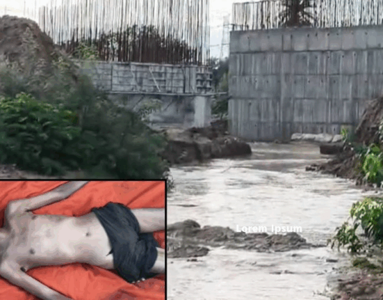 "Rescue team members recovering the body of a laborer swept away by floodwaters near a culvert construction site in Korbi village, Korba district."